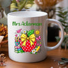 A white ceramic mug with a custom printed design featuring a cartoon dog wearing sunglasses and a blue shirt, surrounded by colorful books and school supplies. The text on the mug reads 'Mr Forsythe' and 'Teachers make the world brighter place'.