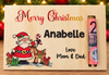 Personalized wooden Christmas advent calendar for Mom & Dad, engraved with 'Merry Christmas', the name 'Anabelle', and 'Love Mom & Dad', featuring a Santa Claus and reindeer illustration, with a rolled banknote showing the number 2 on the right side.