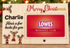A personalized wooden Christmas gift card holder featuring the text 'Merry Christmas', 'Charlie', and 'Here's a few bucks for you' alongside festive reindeer illustrations. A red Lowes Rewards Club card is displayed in the center slot, set against a blurred holiday background.