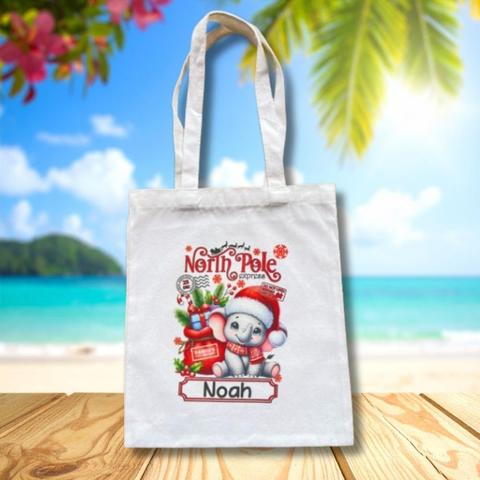 Personalised Christmas tote bag featuring a cute elephant wearing a Santa hat with custom name.