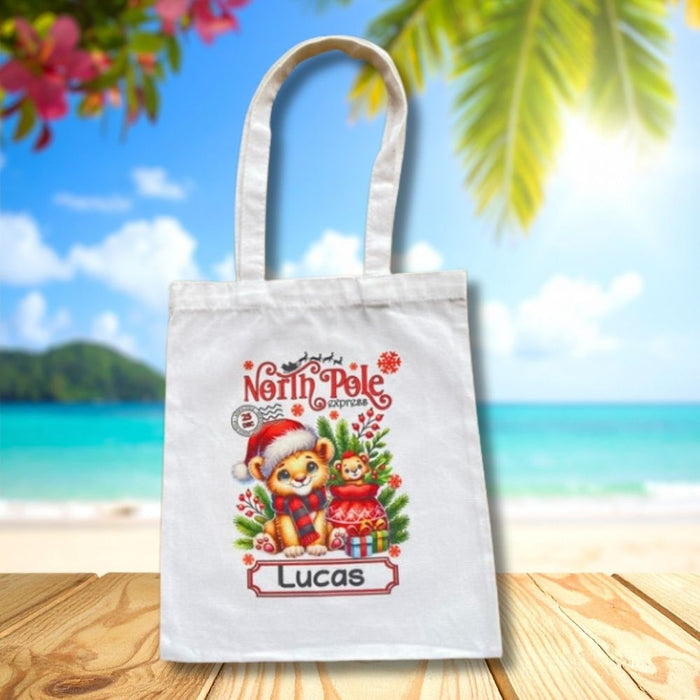 Personalised Christmas tote bag featuring a Christmas lion and presents with custom child name.
