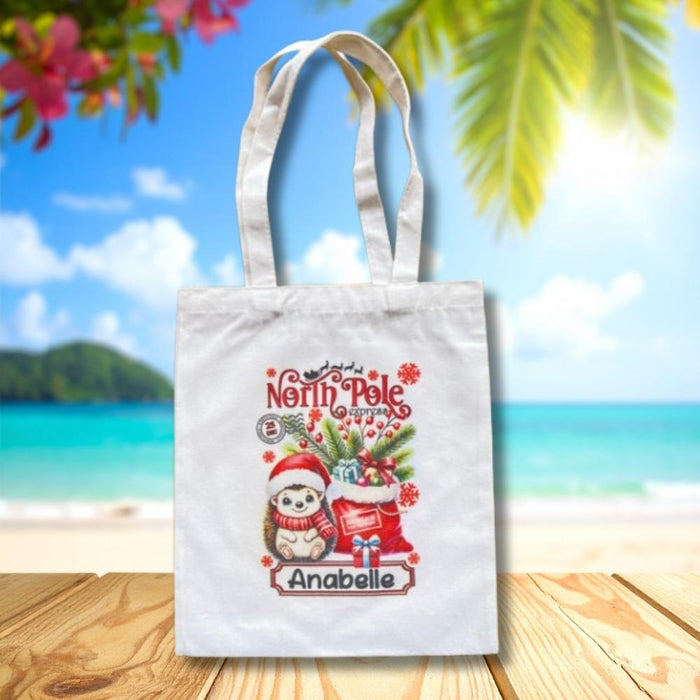 Personalised Christmas tote bag featuring a Christmas Hedgehog and presents with custom child name.