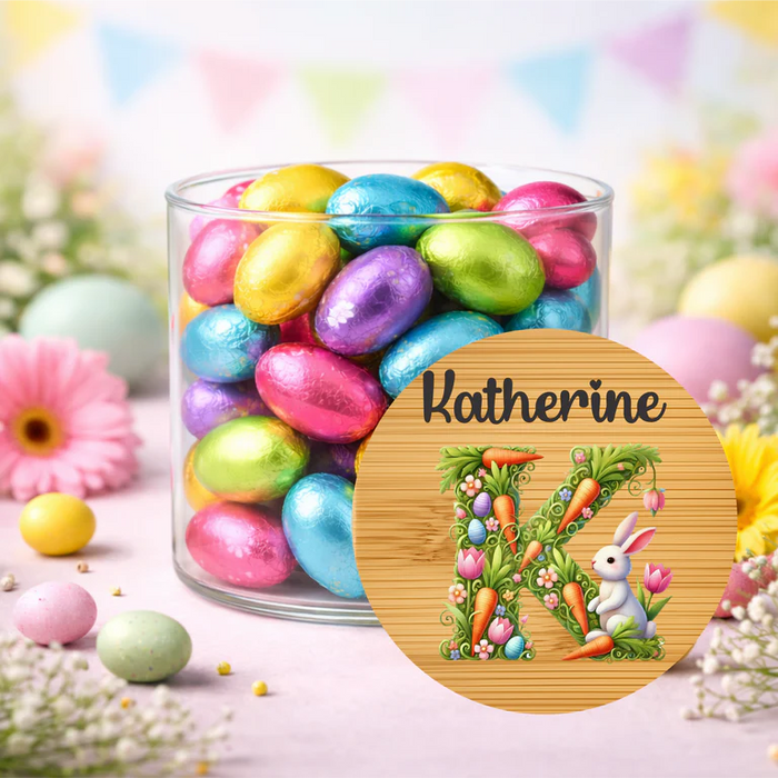 Jar of colorful Easter eggs with a decorative coaster featuring 'Katherine' and Easter-themed design.