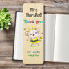 A personalized wooden bookmark featuring a cartoon bear dressed as a bee and the text 'Mrs Marshall Thank you for helping me grow', displayed on an open book with a small green succulent in the corner.